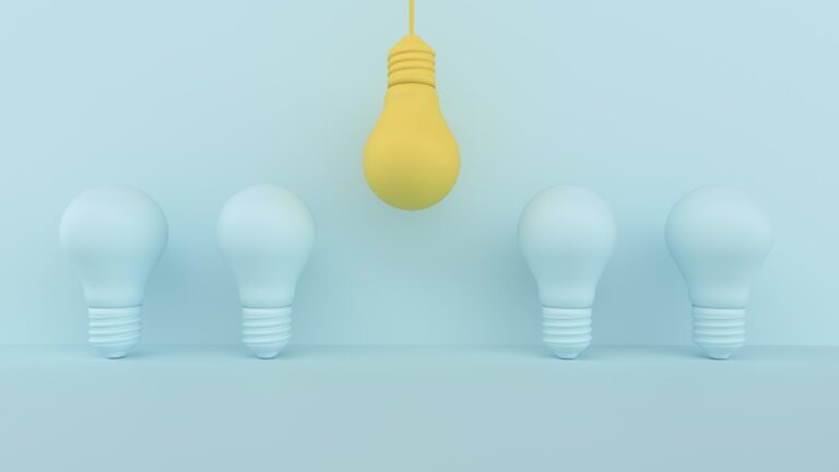 Yellow bulb outstanding on blue pastel background.