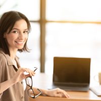 smiling-young-worker-with-blank-screen-laptop-YU7CVY8.jpg